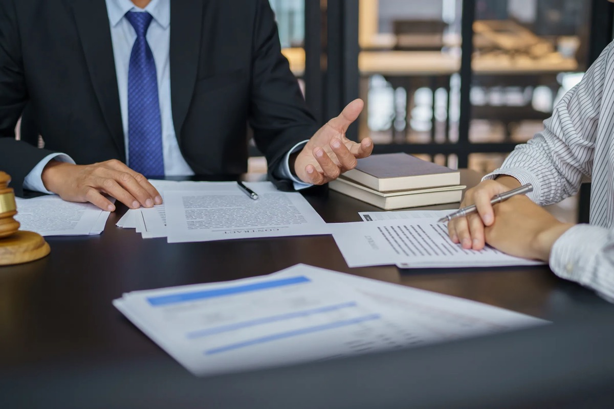 Attorney reviewing legal contract and case documents
